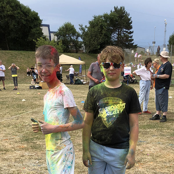 Students covered in multicoloured paint