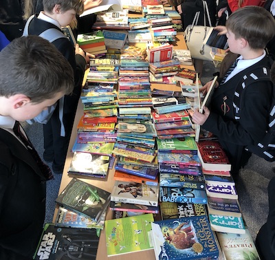 Students looking through all the books on offer