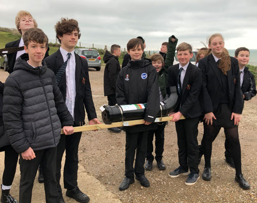 Students carrying the recycling point