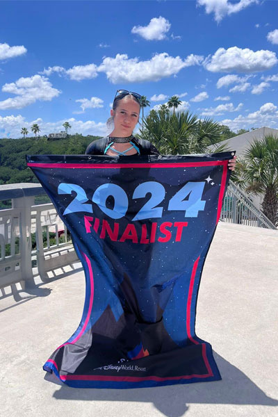Nikki holding her 2024 finalist flag