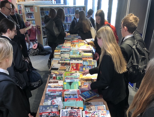 Students & teachers looking through all the books on offer