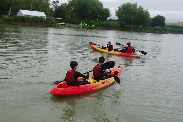 Students in kayaks on the river